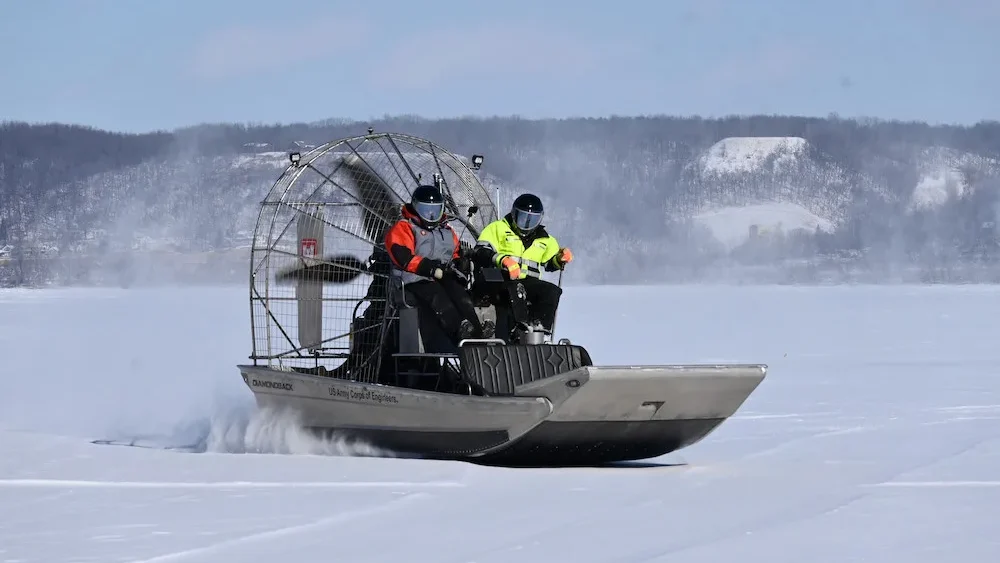 U.S. Army Corps of Engineers, St. Paul District Survey Technicians Dan DeVaney, left, and Bill Chelmowski ride on an airboat above the ice at Lake Pepin, near Red Wing, Minnesota Feb. 9.