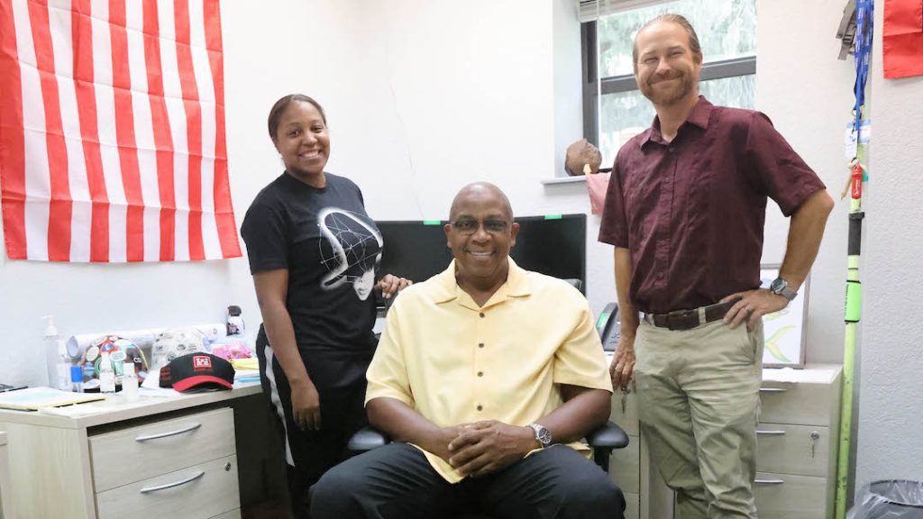 Mark White, U.S. Army Corps of Engineers Panama City Site Office lead civil engineer, seated, poses for a photo with Rhashana Williams, administrative assistant, and Waylon Register, Panama City Site Manager, at the site office in Panama City, Florida, July 13, 2023. White will be retiring after almost 40 years of service to the Mobile District, the Panama City Site Office, and the Corps later this fall. (U.S. Army photo by Chuck Walker)