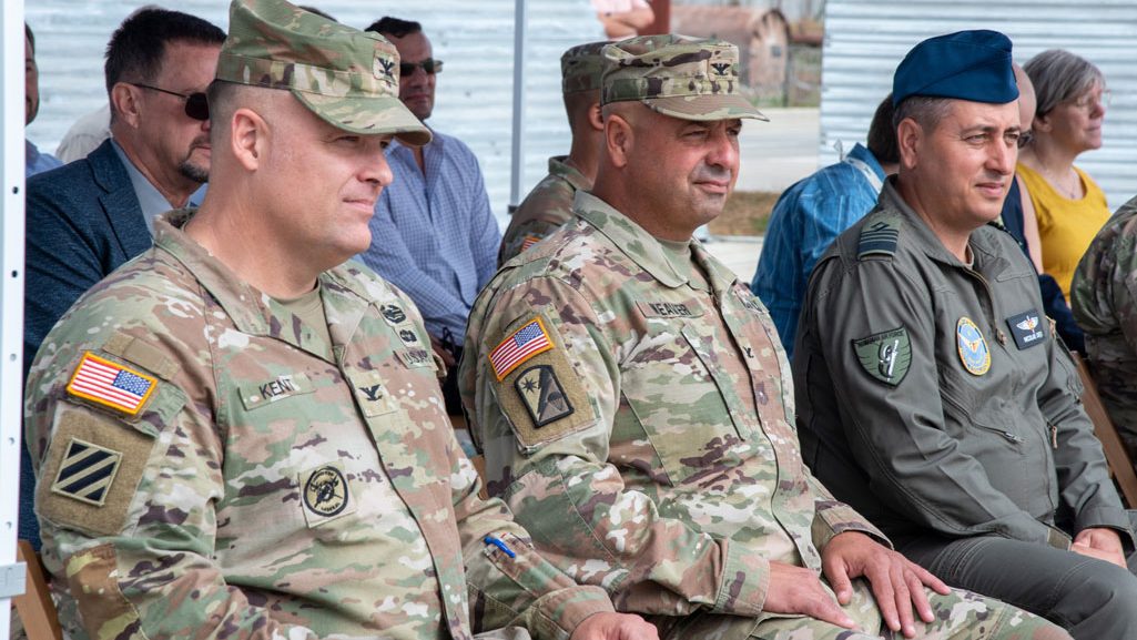 U.S. Army Corps of Engineers, Europe District Commander Col. Dan Kent, U.S. Army Support Group Black Sea Commander Col. Kesler Weaver and Mihail Kogalniceanu Air Base Commander Romanian Air Force Col. Nicolae Cretu sit together during a ribbon cutting ceremony for the MK Cargo Apron at MK Air Base, Romania, August 7, 2024. The new cargo pad will support fixed wing and rotary wing aircraft and is part of an investment of more than $100 million in projects on MK Air Base being managed by the U.S. Army Corps of Engineers.