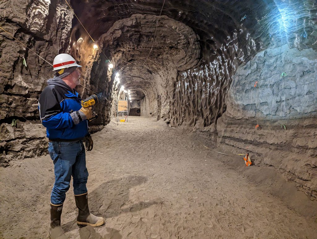 Operations manager Gary Larsen trains a flashlight on an ice formation within the Permafrost Tunnel Research Facility while sharing information about the tunnel with visitors. The tunnel is operated by the Cold Regions Research and Engineering Laboratory, part of the U.S. Army Corps of Engineers. U.S. ARMY PHOTO BY EVE BAKER, FORT WAINWRIGHT PUBLIC AFFAIRS OFFICE