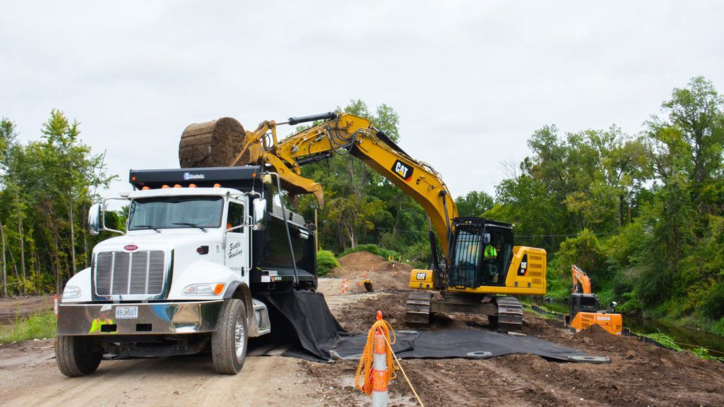 A loader skillfully transfers potentially contaminated soil into the bed of a dump truck, being careful not to spill dirt over the sides, Sept. 5, 2023, as part of ongoing remediation efforts along Coldwater Creek under the Formerly Utilized Sites Remedial Action Program. The soil is then taken to a St. Louis Airport site to be loaded onto railcars and shipped to an approved disposal facility outside Missouri. USACE PHOTO BY JEREMY IDLEMAN