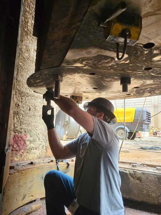 A member of the Regional Rivers Repair Fleet with the Huntington District prepares a bearing plate template at Wilson Lock May 15, 2025, used by the repair team to ensure bolt holes would align during installation of new miter gate components. USACE PHOTO BY JUSTIN REED