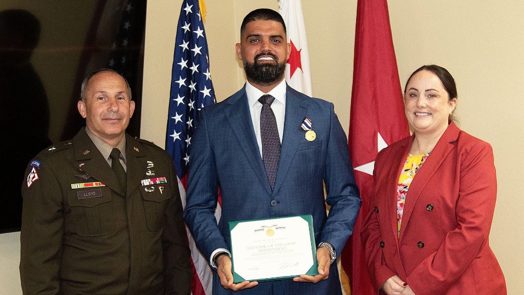Mohannad Ali of San Diego, center, poses for a picture with Brig. Gen. Lloyd, U.S. Army Corps of Engineers South Pacific Division commander, left, and Kate Needham-Cano, senior community representative and military and veterans Liaison for Rep. Sara Jacobs, California’s 51st Congressional District, right, during an Aug. 26 ceremony in San Diego. The Secretary of Defense Medal was awarded to Ali for his actions after being injured as a contractor in 2010 while on assignment in Iraq for the USACE Gulf Region District. (Photo by Dena O’Dell, USACE Los Angeles District) (Photo Credit: Courtesy)