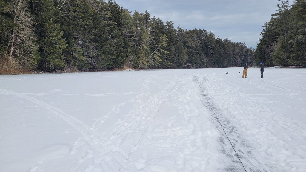 CRREL researchers test DAS-Ice on Storrs Pond in Hanover, New Hampshire. DAS-ICE turns a fiber-optic cable laid onto the ice surface into a vibration monitoring sensor that can be used to determine freshwater ice thickness.