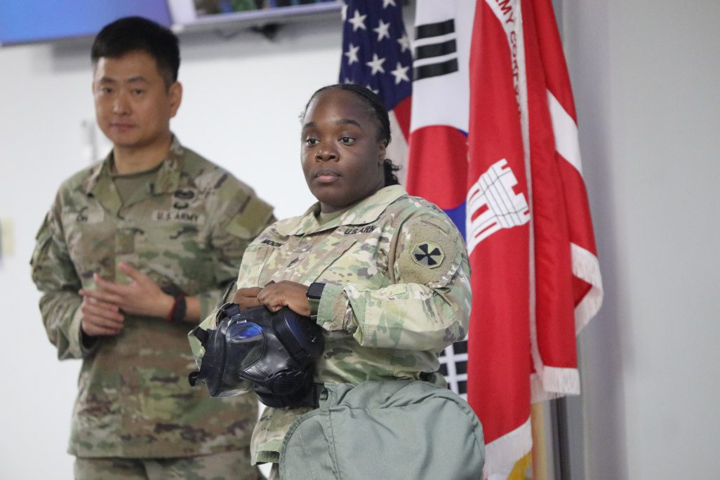 Sgt. 1st Class Carmine Moon, Eighth Army protection directorate CBRN non-commissioned officer in charge, (pictured with Maj. Hyung B. Oh, Design and Construction Agent & Security, Plans, and Operations, U.S. Army Corps of Engineers – Far East District conducted the chemical, biological, radiological, and nuclear defense (CBRN defense) training with the USACE FED Emergency Essential Civilians (EECs) and Mission Essential Civilians (MECs) employees Aug. 26, 2025, at Camp Humphreys, South Korea. She emphasized it is “vital that, MECs, and civilians engage in this training because emergencies don’t discriminate by job title.” (U.S. Army photo by Monique Freemon)