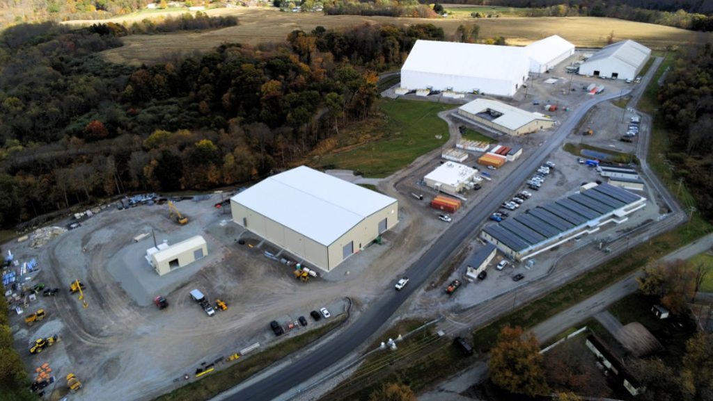 The original building, nicknamed the "white elephant," is shown in the upper right. It is now part of a larger group, each of which is a necessary part of the remediation process. From removal from the trenches to exiting from the site, the highly trained workers involved in the remediation process all have specialized qualifications to ensure the safety of workers and the community. USACE PHOTO BY JEFFERY HARRIS