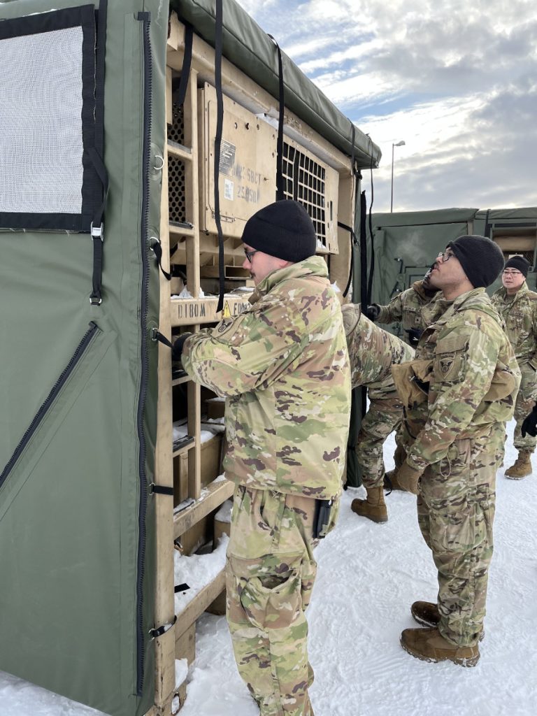 Soldiers (MOS 92G) assemble the Mobile Insulation System for Energy Reduction (MISER) panels during the installation test at Fort Wainwright, Alaska.