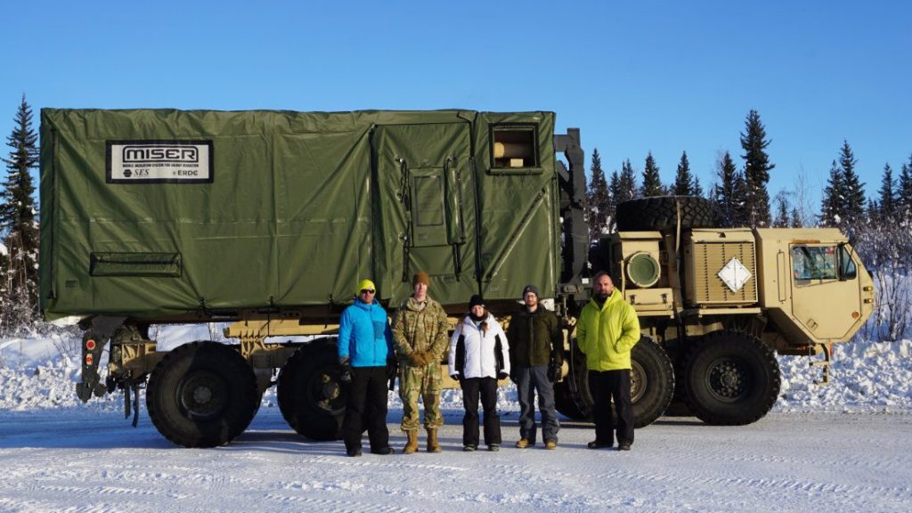 The U.S. Army Engineer Research and Development and Select Engineering Services project team standing with the Mobile Insulation System for Energy Reduction (MISER) system at Fort Wainwright, Alaska. USACE COURTESY PHOTO BY DAVID SHIELDS, SELECT ENGINEERING SERVICES