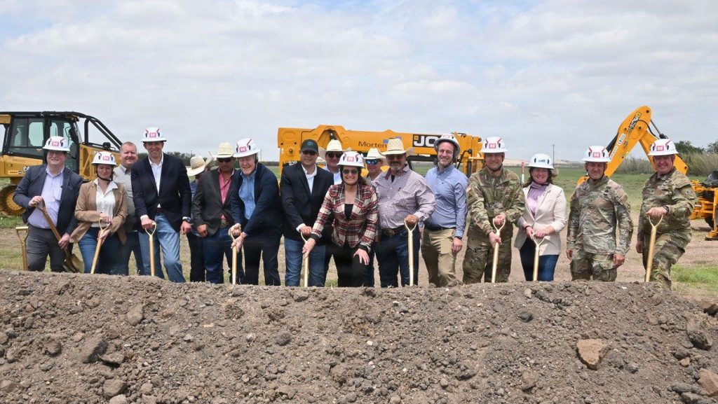 A groundbreaking ceremony was held on April 17, 2026, at Moore Air Base for the New World Screwworm Sterile Fly Production Facility. Once complete and fully operational, the facility will produce approximately 300 million sterile flies per week. Pictured from right to left in helmets are U.S. Army Corps of Engineers’ Fort Worth District Commander Col. Calvin Kroeger, USACE Southwestern Division Commander Brig. Gen. George Walter, Mortenston Vice President and General Manager Kelly McNamara, USACE Commander Lt. Gen. William “Butch” Graham Jr., Principal Deputy Assistant Secretary for the Army for Installations, Energy and Environment Dr. Jeff Waksman, U.S. Department of the Agriculture Secretary Brooke Rollins, Senator John Cornyn, Under Secretary of Agriculture for Marketing and Regulatory Programs Mr. Dudley Hoskins, USDA Animal and Plant Health Inspection Service Acting Administrator Kelly Moore, and USDA Deputy Director for New World Screwworm Directorate Chris Needham. Others in the photo are members of the USDA’s Veterinary Services “Tick Riders”. USACE PHOTO BY PATRICK ADELMANN