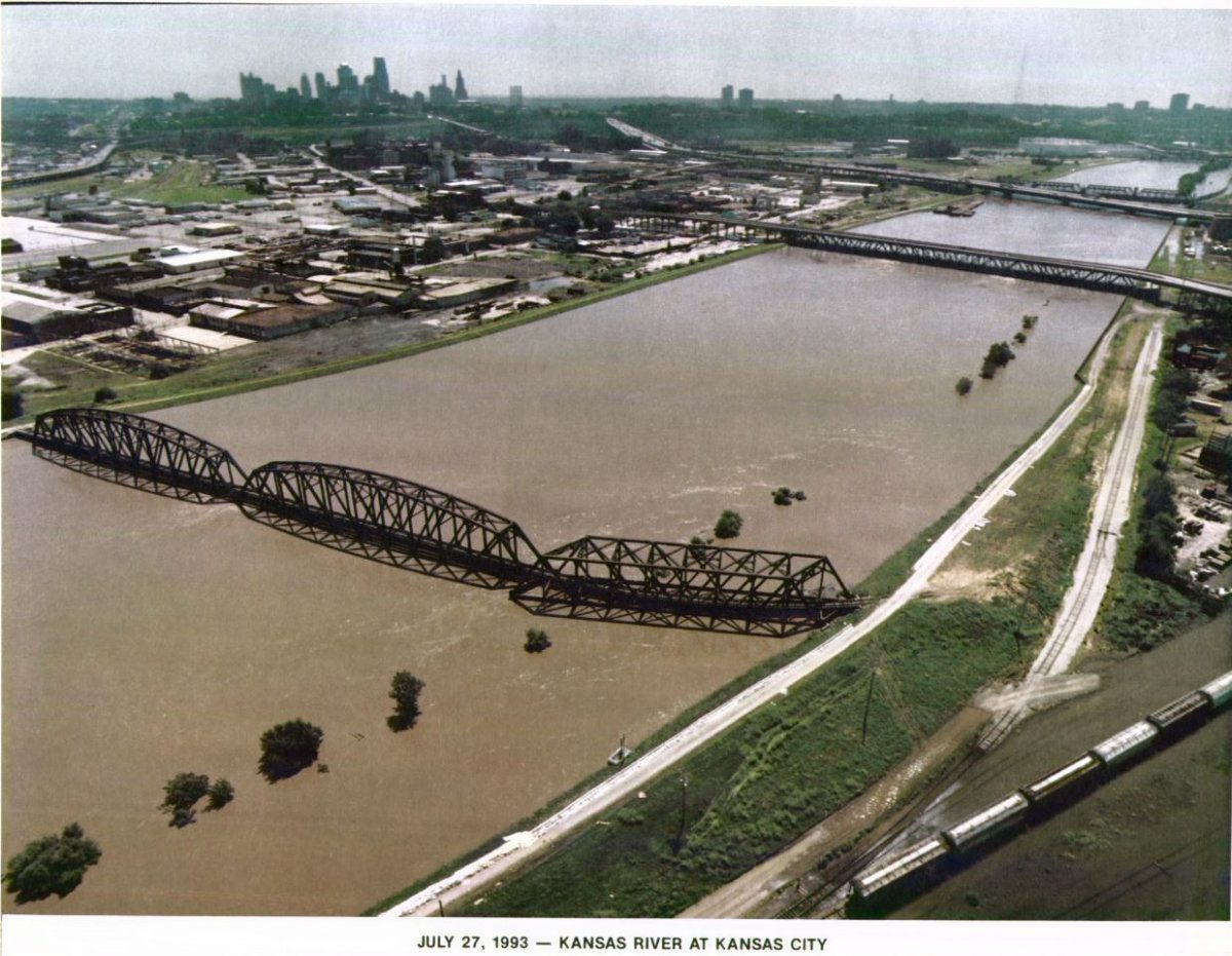High water flood conditions along the Kansas River near a city bridge during the historic July 1993 flood event.