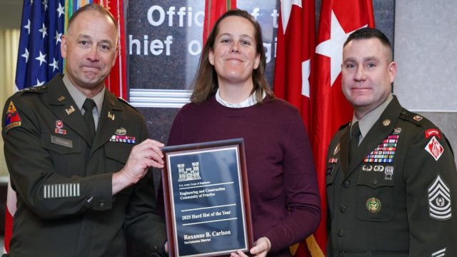 Sacramento District employee, Roxanne Carlson (center), receives the 2025 USACE Hard Hat of the Year award from the 56th Chief of Engineers and Commanding General of the U.S. Army Corps of Engineers Lt. Gen. William H. "Butch" Graham, Jr. and Command Sergeant Major Douglas Galick at a ceremony held at the USACE headquarters building in Washington, D.C. on January 23, 2026. U.S. ARMY PHOTO BY DIANE RIVERA ESTELLA